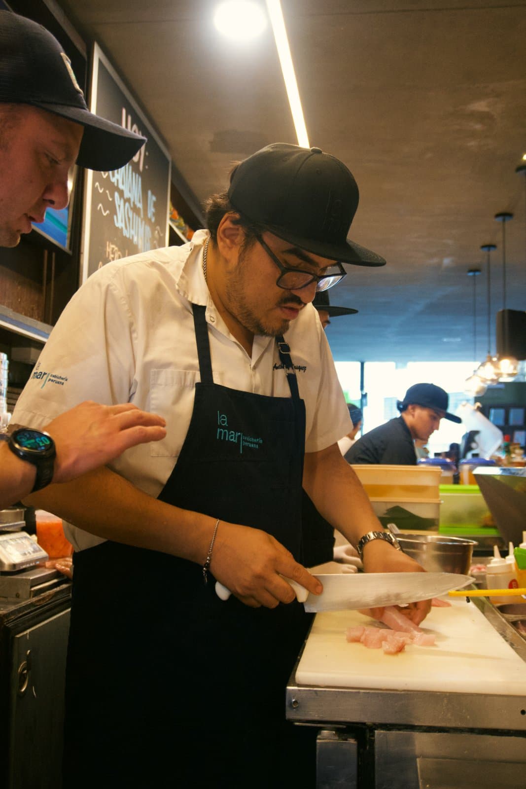 Chef Anthony Vasquez slicing snapper on the ceviche line at La Mar
